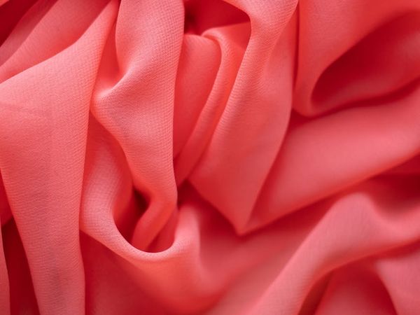 Abstract visual of gentle air currents flowing, colored in pink and grey.